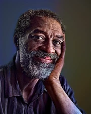 Black elder smiling after finishing his legacy book